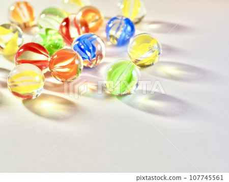 many marbles on white background 107745561