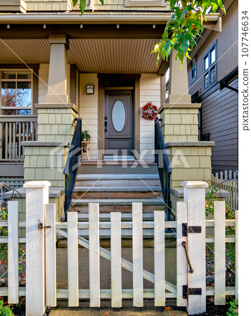 A perfect neighbourhood. Porch and entrance of a nice residential house 107746634