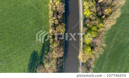 Aerial River Between Trees and Meadows 107746859