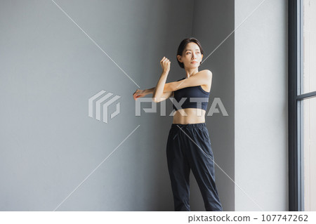 Middle-aged woman stretching at the gym Middle-aged woman stretching at the gym 107747262