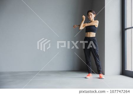 Middle-aged woman stretching at the gym Middle-aged woman stretching at the gym 107747264