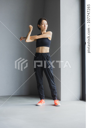 Middle-aged woman stretching at the gym Middle-aged woman stretching at the gym 107747265