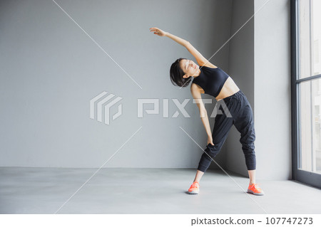 Middle-aged woman stretching at the gym Middle-aged woman stretching at the gym 107747273