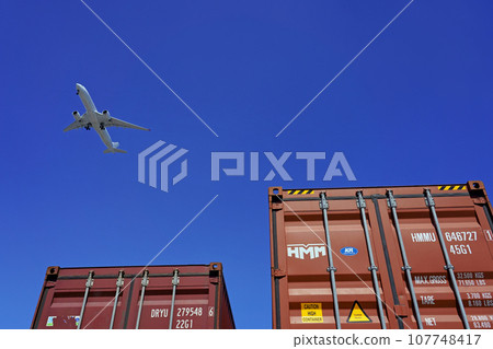 Airplane and sea container (2 pieces) flying in clear skies Airplane and sea container (2 pieces) flying in clear skies 107748417