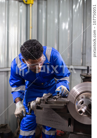 Technician worker man African American wearing uniform safety working machine lathe metal brake 107750051