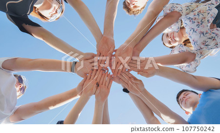Seven boys and girls join hands as a sign of strong friendship. 107750242