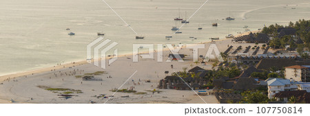 Awesome white sandy beach and turquoise ocean in zanzibar at sunset 107750814