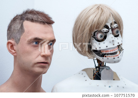 heads of anthropomorphic robots capable of imitating emotions, without face skin and with face skin, on a white background 107751570