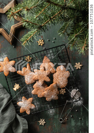 Gingerbread cookies christmas flat lay composition on green wooden table wit fir tree decorations. Top view, xmas card Gingerbread cookies christmas flat lay composition on green wooden table wit fir tree decorations. Top view, xmas card 107751836