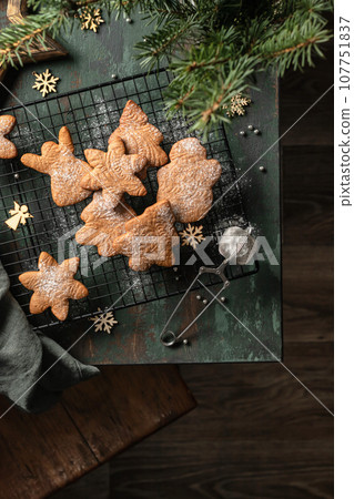 Gingerbread cookies christmas flat lay composition on green wooden table wit fir tree decorations. Top view, xmas card 107751837