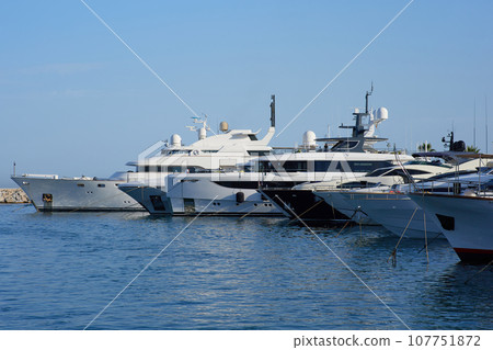 Luxury yacht marina. Vacations And Tourism Concept, Beautiful white modern yachts at sea port. Luxury yacht marina. Vacations And Tourism Concept, Beautiful white modern yachts at sea port. 107751872