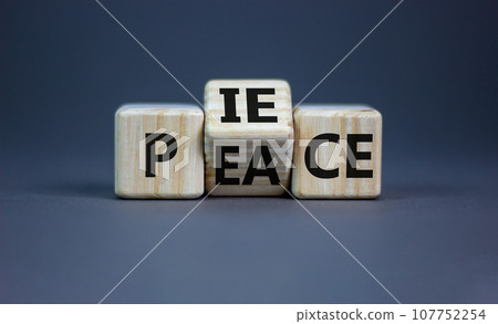 Piece of peace symbol. Turned cubes and changed the word 'piece' to 'peace'. Beautiful grey background, copy space. Business, piece of peace concept. 107752254