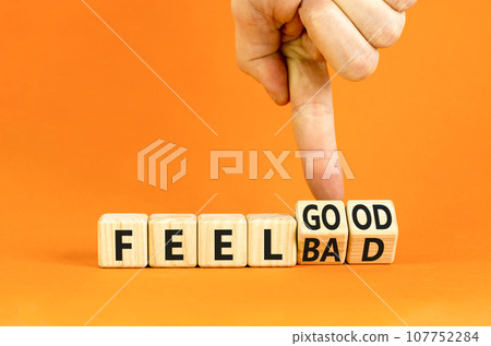 Feel good or bad symbol. Businessman turns wooden cubes and changes word Feel bad to Fell good. Beautiful orange table orange background. Business feel good or bad concept. Copy space. Feel good or bad symbol. Businessman turns wooden cubes and changes word Feel bad to Fell good. Beautiful orange table orange background. Business feel good or bad concept. Copy space. 107752284