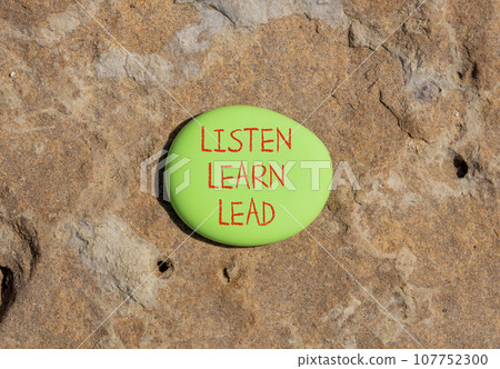Listen learn lead symbol. Concept word Listen Learn Lead on beautiful big green stone. Beautiful brown stone background. Business education listen learn lead concept. Copy space 107752300