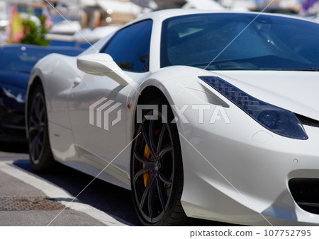 Close up of a white sport car parked in the marina. 107752795