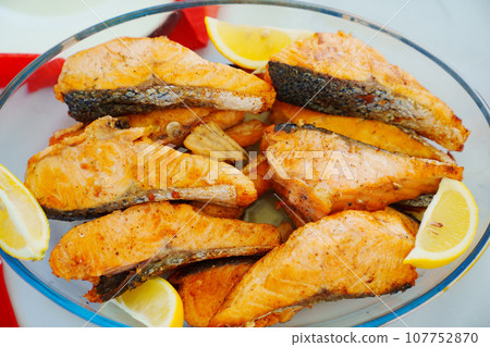 A bowl of grilled red fish. A bowl of grilled red fish. 107752870
