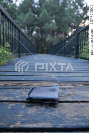 left wallet on a floor at city park  107753002