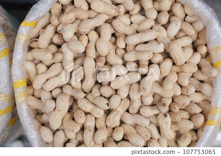 peeled peanuts in a bowl on table peeled peanuts in a bowl on table 107753065