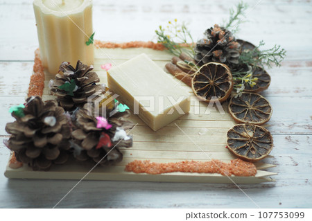Homemade natural soap bar and dry flower on black background  107753099