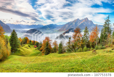 Breathtaking autumn view on suburb of Stansstad city  and Lucerne lake with mountaines and fog. 107753378