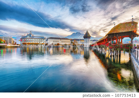 Breathtaking historic city center of Lucerne with famous buildings and old wooden Chapel Bridge (Kapellbrucke) 107753413