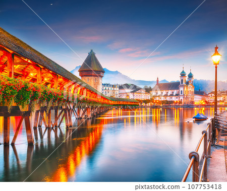 Breathtaking historic city center of Lucerne with famous buildings and old wooden Chapel Bridge (Kapellbrucke) Breathtaking historic city center of Lucerne with famous buildings and old wooden Chapel Bridge (Kapellbrucke) 107753418