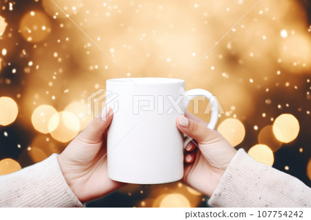 White mug in woman's hands mock up on Christmas background 107754242