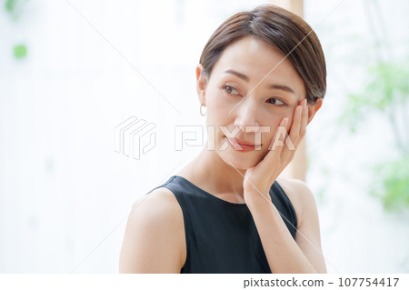 A woman relaxing in the living room 107754417