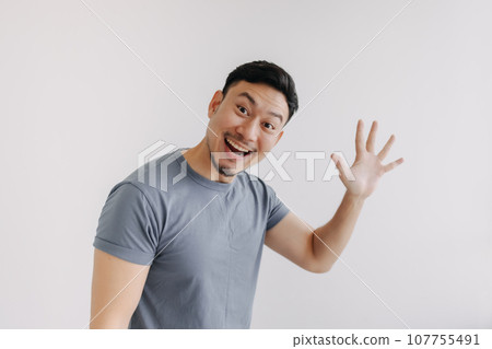 Happy asian man pop out for greeting and say hi, stand isolated on white 107755491