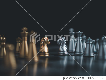 Gold and silver chess pieces in chess board game for business comparison. Leadership concepts, human resource management concepts. 107756112