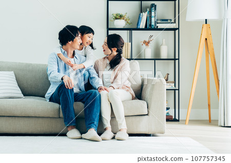 Young family relaxing in the living room 107757345
