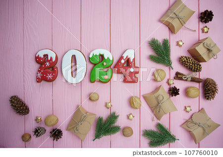 The numbers are gingerbread 2023 on a pink background.  107760010