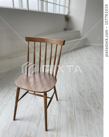 wooden chair in a white room 107761019