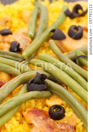 Chicken paella, Mediterranean cuisine, rice, saffron yellow 107761112