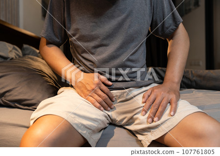 Stressed asian middle aged man suffering from Benign Prostatic Hyperplasia,urinary incontinence,wet his pants,lack of voluntary control over urination,urinary frequency,bladder or prostate problems 107761805