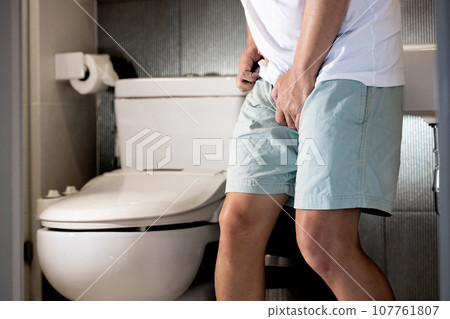 Sick asian middle aged man suffering from Sexually Transmitted Disease(STD),Gonorrhea,Genital Herpes,Venereal disease,inflammation of urethra,Male patient holding crotch,painful or difficult urination 107761807
