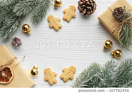 Christmas gifts, gingerbread cookies, decorations with christmas tree. Christmas gifts, gingerbread cookies, decorations with christmas tree. 107762458