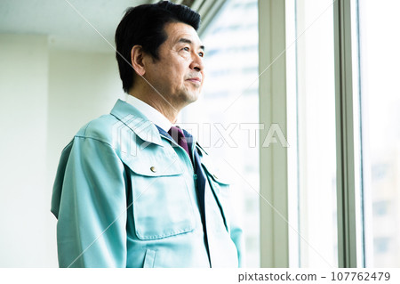 Middle-aged businessman in work clothes working in the office Middle-aged businessman in work clothes working in the office 107762479