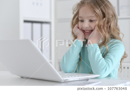 Cute and happy little girl children using laptop computer 107763048