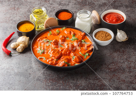 Chicken tikka masala spicy curry meat food over concrete background closeup. Horizontal Chicken tikka masala spicy curry meat food over concrete background closeup. Horizontal 107764753