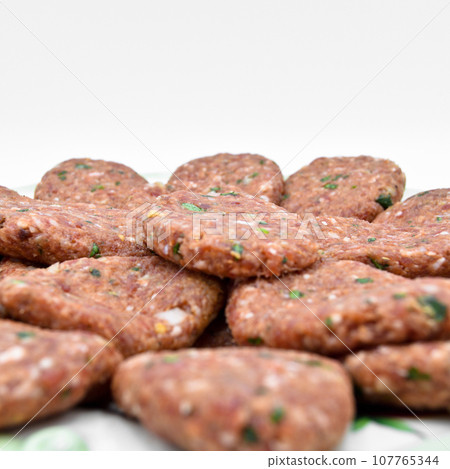 Raw beef meatballs made with various homemade spices, raw beef kofte kofta Raw beef meatballs made with various homemade spices, raw beef kofte kofta 107765344