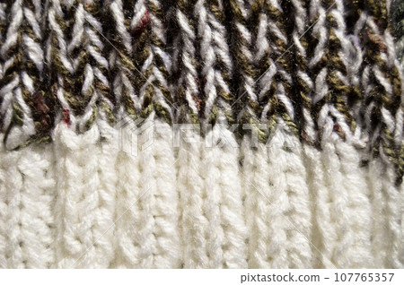 Handmade knitted fabric white and grey wool background texture Handmade knitted fabric white and grey wool background texture 107765357