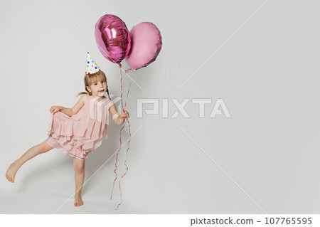 Happy kid with pink balloon on white studio wall banner background 107765595