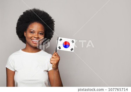 Korean woman holding flag of Korea Education, business, citizenship and patriotism concept 107765714
