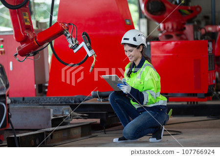 Female technician modern factory, Technical of robot operation department. Female technician modern factory, Technical of robot operation department. 107766924
