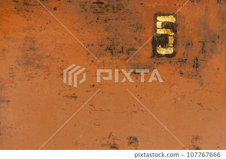 Old metal painted texture. Red painted background . Painted surface with rust. The plate with the number 5 on a rusty metal wall. Old uneven iron surface. Perfect for grunge design. Old metal painted texture. Red painted background . Painted surface with rust. The plate with the number 5 on a rusty metal wall. Old uneven iron surface. Perfect for grunge design. 107767666