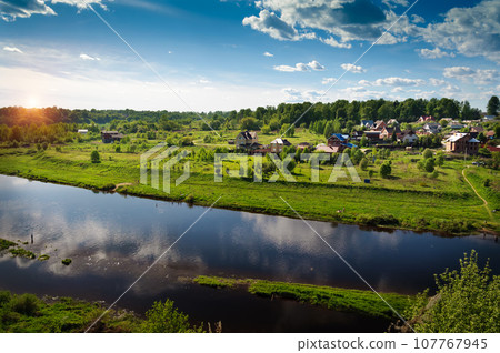 Sunset cuts through the clouds over the river Volga. Rzhev 107767945