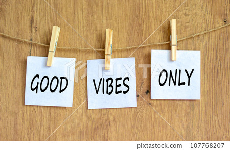 Good vibes only symbol. Concept word Good vibes only on beautiful white paper on wooden clothespin. Beautiful wooden table wooden background. Business motivational good vibes only concept. Copy space. 107768207