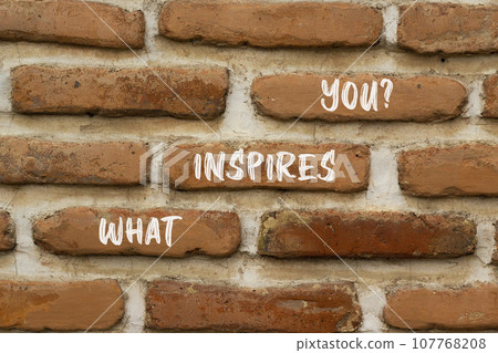 What inspires you symbol. Concept words What inspires you on beautiful brown brick. Beautiful red brown brickwall background. Business motivational what inspires you concept. Copy space. 107768208