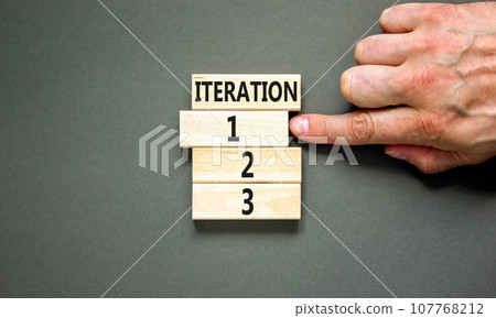 Time to iteration 1 symbol. Concept word Iteration 1 2 3 on wooden block. Businessman hand. Beautiful grey table grey background. Business planning and time to iteration 1 concept. Copy space. Time to iteration 1 symbol. Concept word Iteration 1 2 3 on wooden block. Businessman hand. Beautiful grey table grey background. Business planning and time to iteration 1 concept. Copy space. 107768212